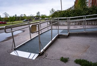 A ramp for people with disabilities near a public building. An iron ramp for the disabled.