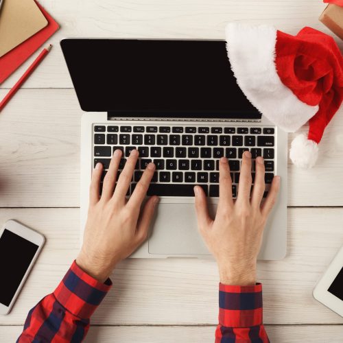 Man's,Hands,On,Laptop.,Work,On,Christmas,Eve.,Top,View