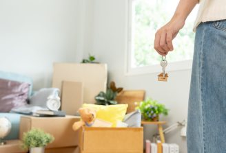 Moving,House,,Relocation.,Woman,Hold,Key,House,Keychain,In,New