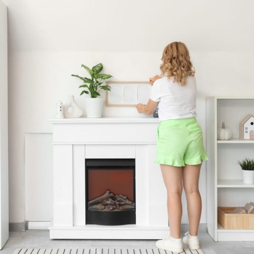 Female,Interior,Designer,Hanging,Blank,Frame,On,Light,Wall,In